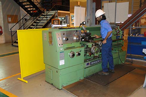 DARVICO technician operating manufacturing equipment